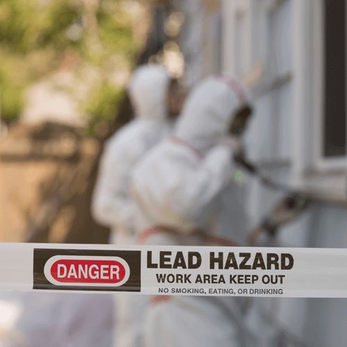 OSHA Lead Awareness Training two workers in full PPE removing lead paint