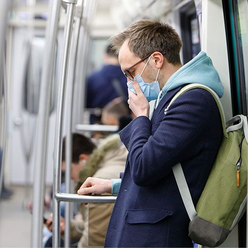 OSHA Bloodborne Pathogens Training man wearing a facemask traveling using underground rail