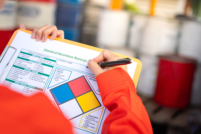 Person marking marking a hazmat incident checklist