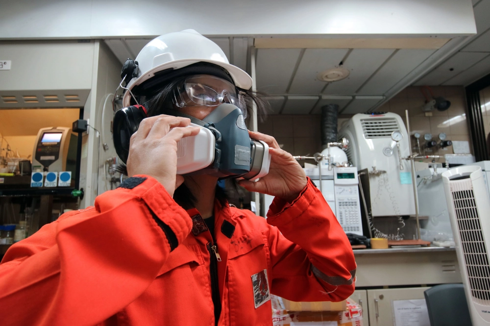 Worker fit testing respirator before use