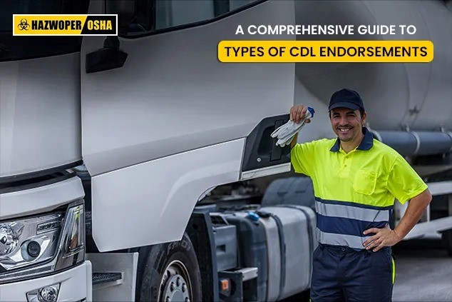 A commercial driver standing in front of his truck. 